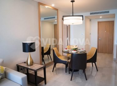 Dining area of comfortable studio flat or hotel room. Set dining table prepared for dinner with Asian cuisine. City apartment and interior concept